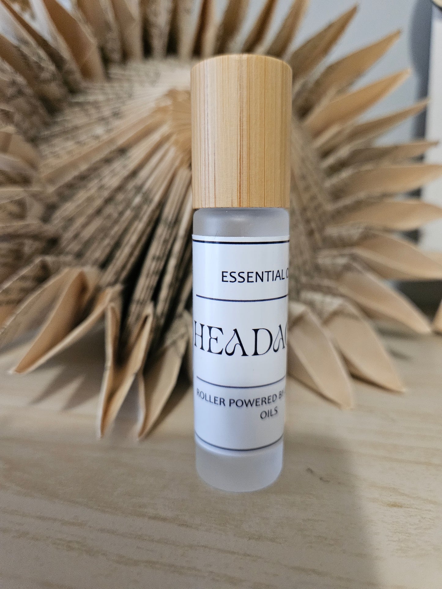 Roller bottle with wooden cap on. Bold text label