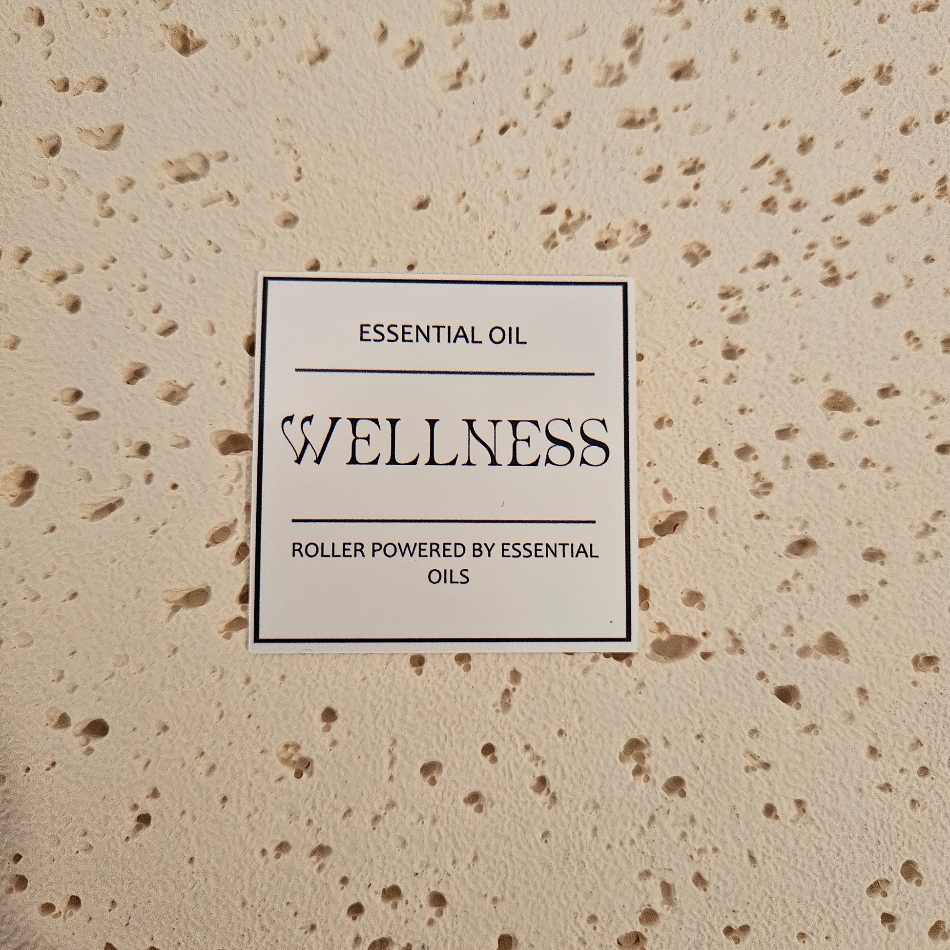  'Wellness' essential oil roller packaging label. Bold text